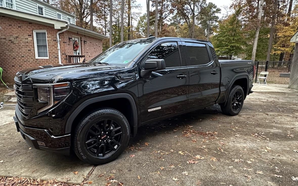 Freshly detailed black GMC truck in a Hampton Roads driveway